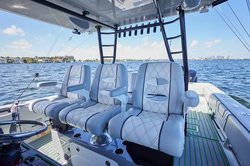  Yacht Photos Pics Luxury seating on 2022 Contender 44 ST boat, featuring plush white upholstery and ocean backdrop.