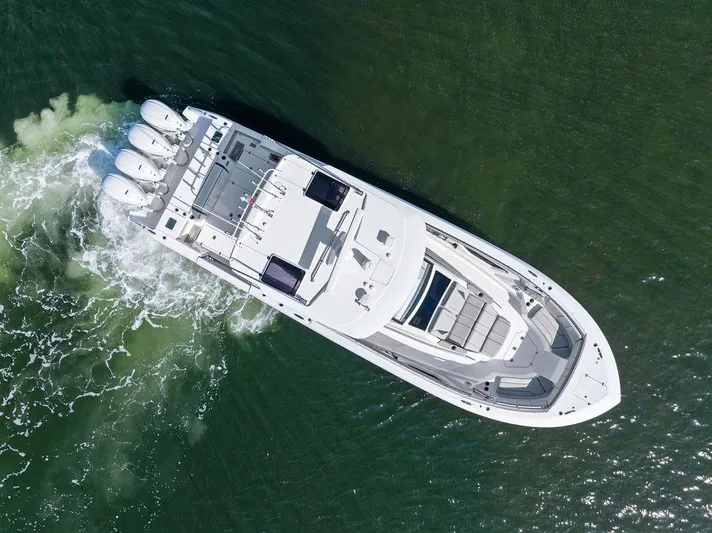 Yacht Photos Pics 2022 Pursuit S 428 Sport boat cruising on water, aerial view.