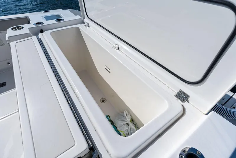  Yacht Photos Pics Open storage compartment on 2022 Pursuit S 428 Sport boat, showcasing spacious interior.