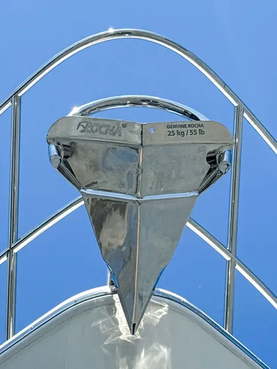 Above Deck Yacht Photos Pics Stainless steel anchor on 2018 Princess S60 yacht against clear blue sky.