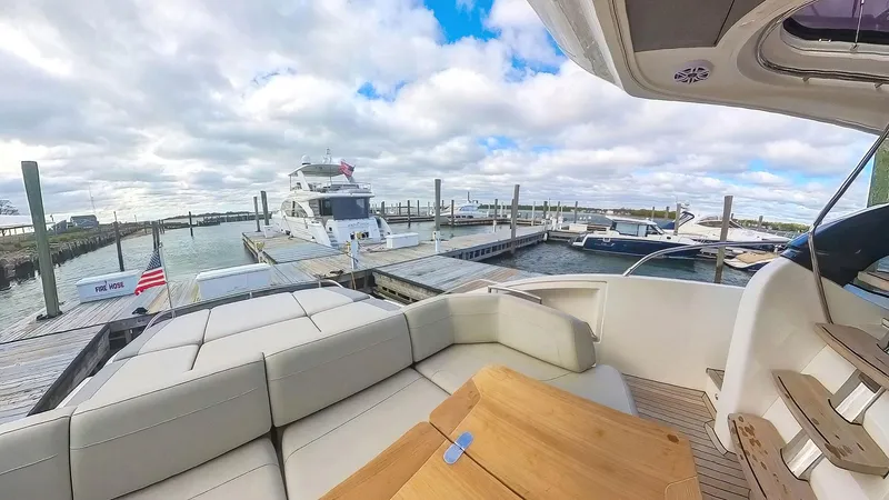 Above Deck Yacht Photos Pics Luxurious 2018 Princess S60 yacht docked at marina with spacious seating area.