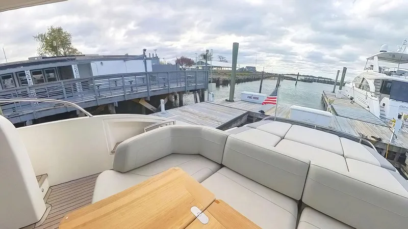 Above Deck Yacht Photos Pics Luxurious 2018 Princess S60 yacht docked at a marina with comfortable seating.