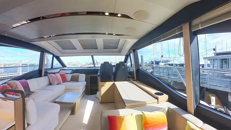 Above Deck Yacht Photos Pics Luxurious interior of a 2018 Princess S60 yacht with modern seating and large windows.