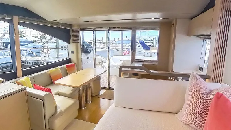 Above Deck Yacht Photos Pics Luxurious 2018 Princess S60 yacht interior with modern seating and marina view.