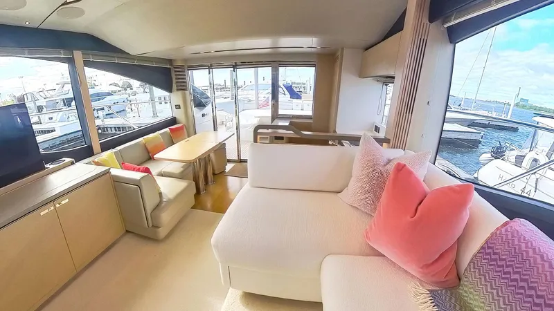 Above Deck Yacht Photos Pics Luxurious 2018 Princess S60 yacht interior with plush seating and marina view.