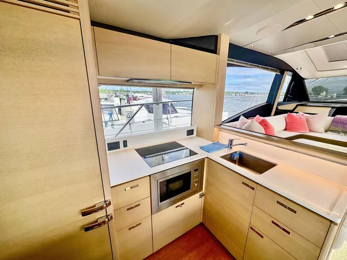 Above Deck Yacht Photos Pics Modern kitchen interior on a 2018 Princess S60 yacht with sleek cabinetry and appliances.