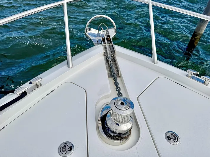 Above Deck Yacht Photos Pics Bow of 2018 Princess S60 yacht with anchor chain and winch over water.