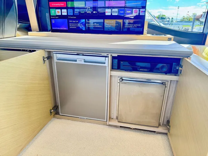 Above Deck Yacht Photos Pics 2018 Princess S60 yacht interior with mini fridge and entertainment system.