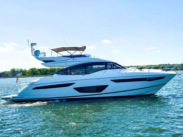 Above Deck Yacht Photos Pics 2018 Princess S60 yacht cruising on a sunny day, showcasing sleek design and luxury features.