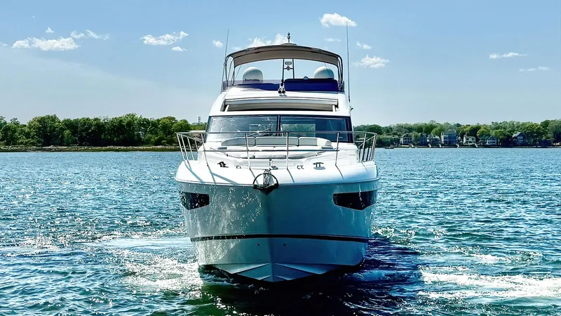 Above Deck Yacht Photos Pics 2018 Princess S60 yacht cruising on a sunny day, surrounded by calm blue waters.