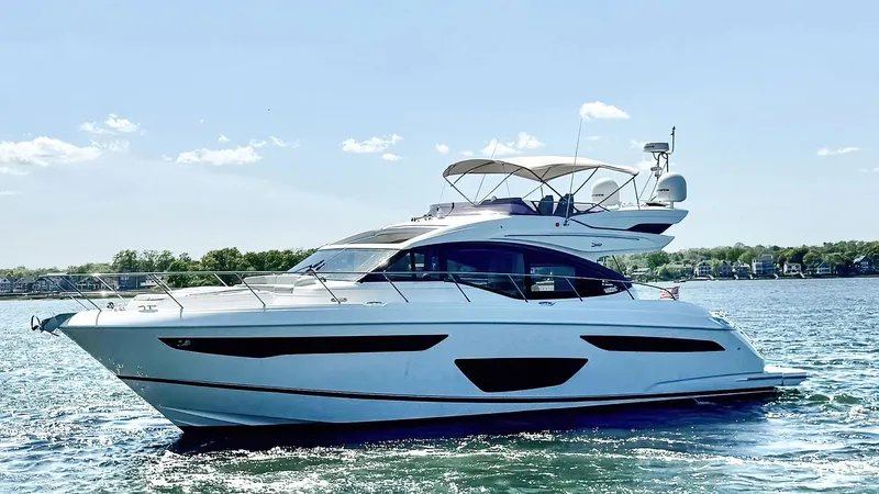 Above Deck Yacht Photos Pics 2018 Princess S60 yacht cruising on a sunny day, showcasing sleek design and luxury.