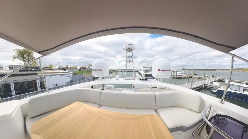 Above Deck Yacht Photos Pics 2018 Princess S60 yacht deck with seating and Raymarine equipment, docked at marina.