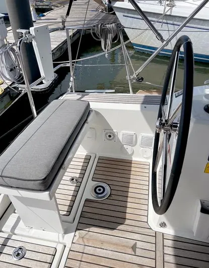 Odyssey Yacht Photos Pics Cockpit of 2022 Beneteau Oceanis 38.1 sailboat with steering wheel and seating.