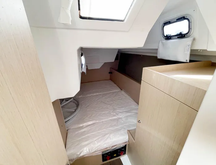 Odyssey Yacht Photos Pics Interior cabin of 2022 Beneteau Oceanis 38.1 yacht, featuring a cozy sleeping area.