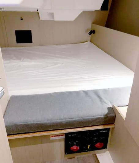 Odyssey Yacht Photos Pics Cabin interior of 2022 Beneteau Oceanis 38.1 with bed and control panel.