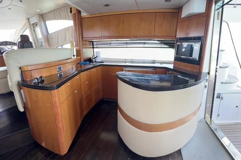  Yacht Photos Pics Luxurious 2007 Sunseeker Manhattan 66 yacht interior with modern kitchen and sleek wood finishes.