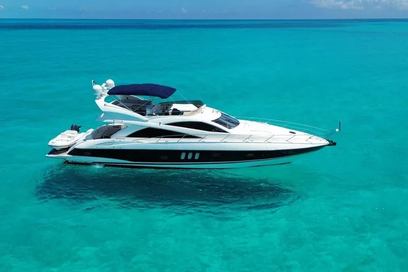  Yacht Photos Pics Luxury Sunseeker Manhattan 66 yacht, 2007 model, cruising on clear turquoise waters.