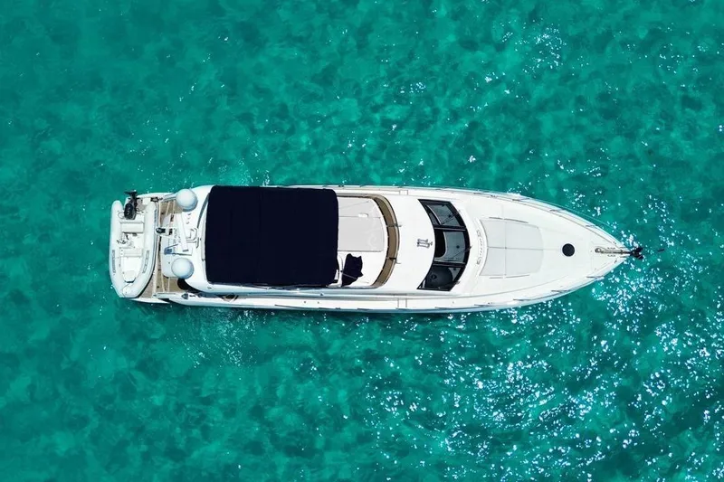  Yacht Photos Pics Aerial view of 2007 Sunseeker Manhattan 66 yacht on turquoise water.