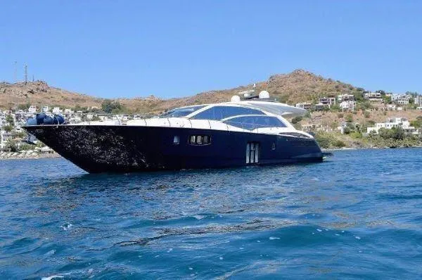  Yacht Photos Pics Luxury Absolute 70 yacht from 2012 cruising on clear blue waters near a scenic coastline.