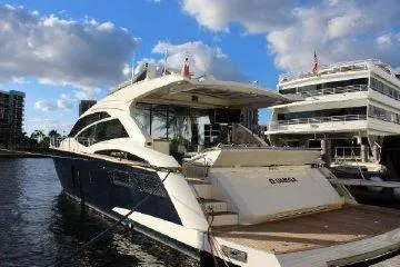  Yacht Photos Pics Luxury Absolute 70 yacht, 2012 model, docked under a blue sky with clouds.