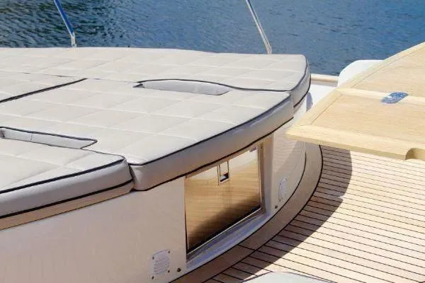  Yacht Photos Pics Luxury yacht deck with cushioned seating, Absolute 70 model, 2012, overlooking serene water.