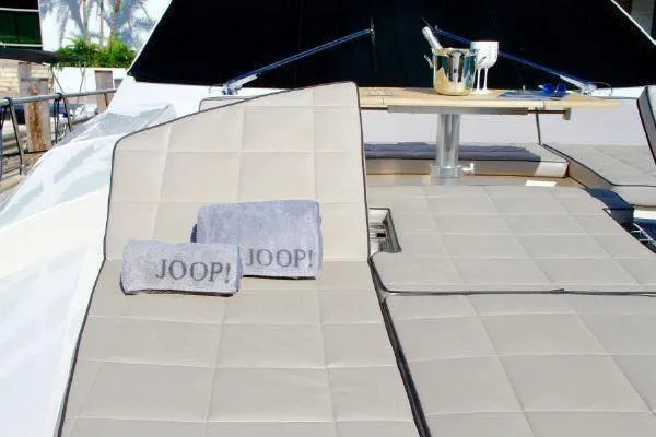  Yacht Photos Pics Luxury yacht sun deck with towels and table, Absolute 70, 2012 model.