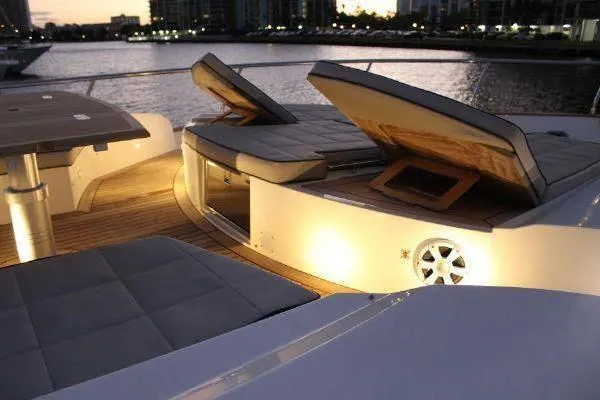  Yacht Photos Pics Luxurious 2012 Absolute 70 yacht deck with cushioned seating and ambient lighting at sunset.