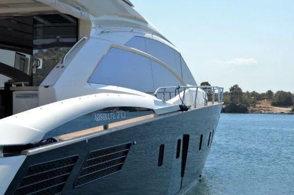  Yacht Photos Pics Luxury Absolute 70 yacht from 2012 on serene water, showcasing sleek design and elegance.