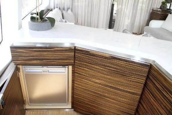  Yacht Photos Pics Luxurious yacht interior with modern wood cabinetry and sleek white countertops, Absolute 70, 2012 model.