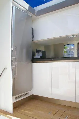  Yacht Photos Pics Modern kitchen interior on a 2012 Absolute 70 yacht, featuring sleek cabinetry and stainless steel appliances.