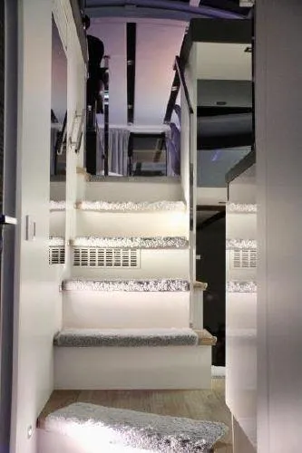  Yacht Photos Pics Interior staircase of a 2012 Absolute 70 yacht, featuring modern design and ambient lighting.