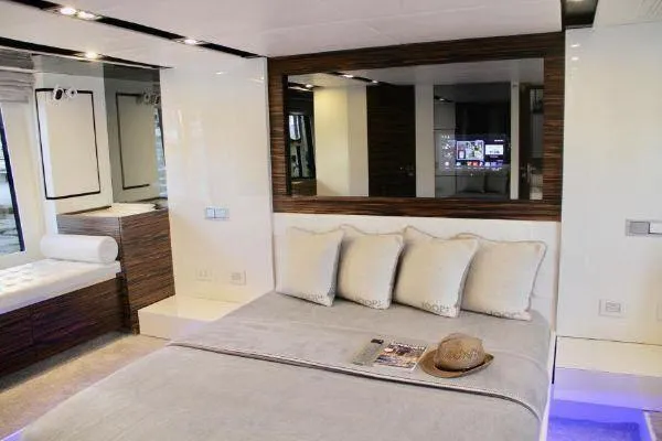  Yacht Photos Pics Luxurious bedroom interior of a 2012 Absolute 70 yacht, featuring modern decor and elegant furnishings.
