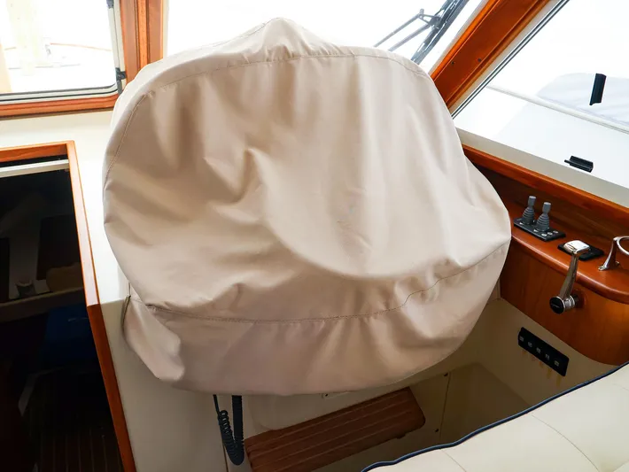 4814ak Yacht Photos Pics Captain's chair with cover on 2009 Legacy 32 boat interior.