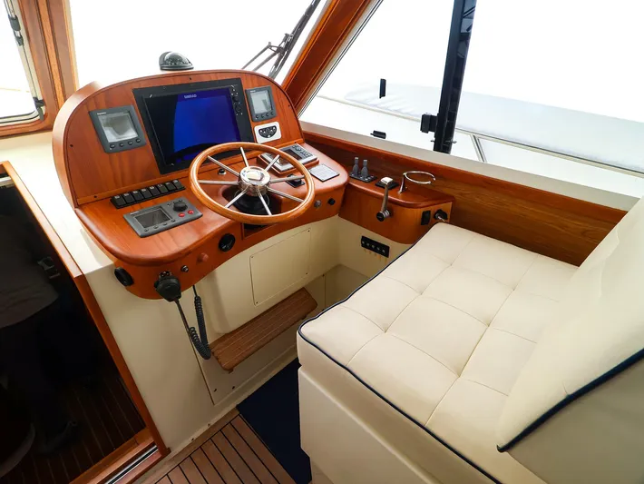 4814ak Yacht Photos Pics Helm of 2009 Legacy 32 boat with wooden dashboard and navigation equipment.