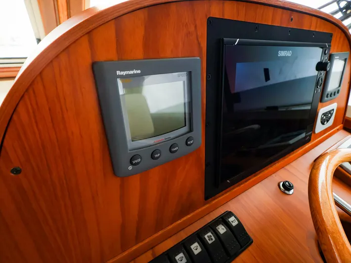 4814ak Yacht Photos Pics Control panel of 2009 Legacy 32 boat with Raymarine and Simrad displays.