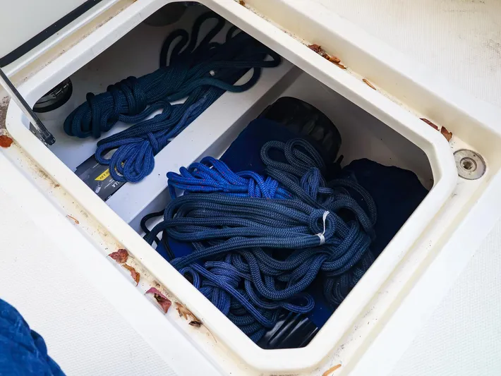 4814ak Yacht Photos Pics Storage compartment on a 2009 Legacy 32 boat with coiled blue ropes.