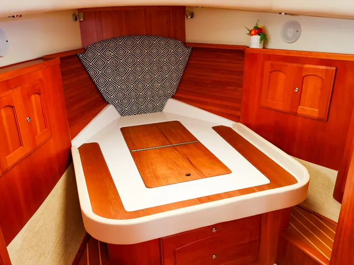 4814ak Yacht Photos Pics Luxurious cabin interior of 2009 Legacy 32 boat with wooden finish and geometric decor.