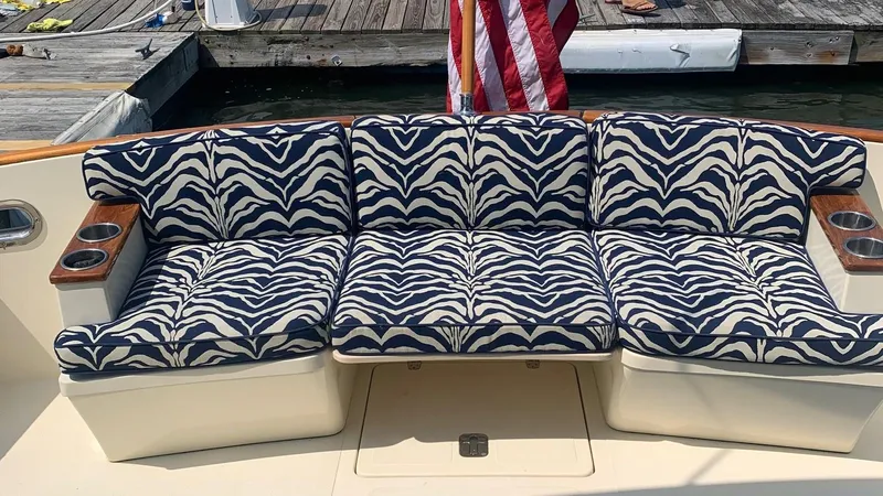 4814ak Yacht Photos Pics Zebra-patterned seating on a 2009 Legacy 32 boat, docked with an American flag.