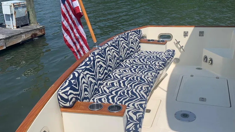 4814ak Yacht Photos Pics 2009 Legacy 32 boat with patterned seating and American flag at dockside.