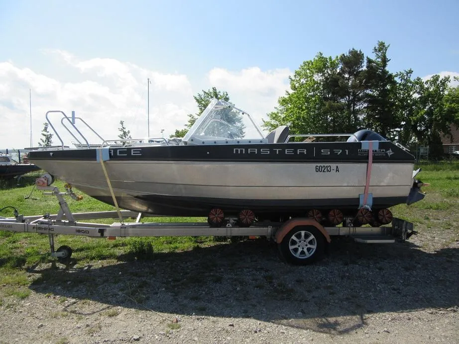 Boat on trailer, Master Pro 571, 2016 model, parked outdoors on a sunny day.