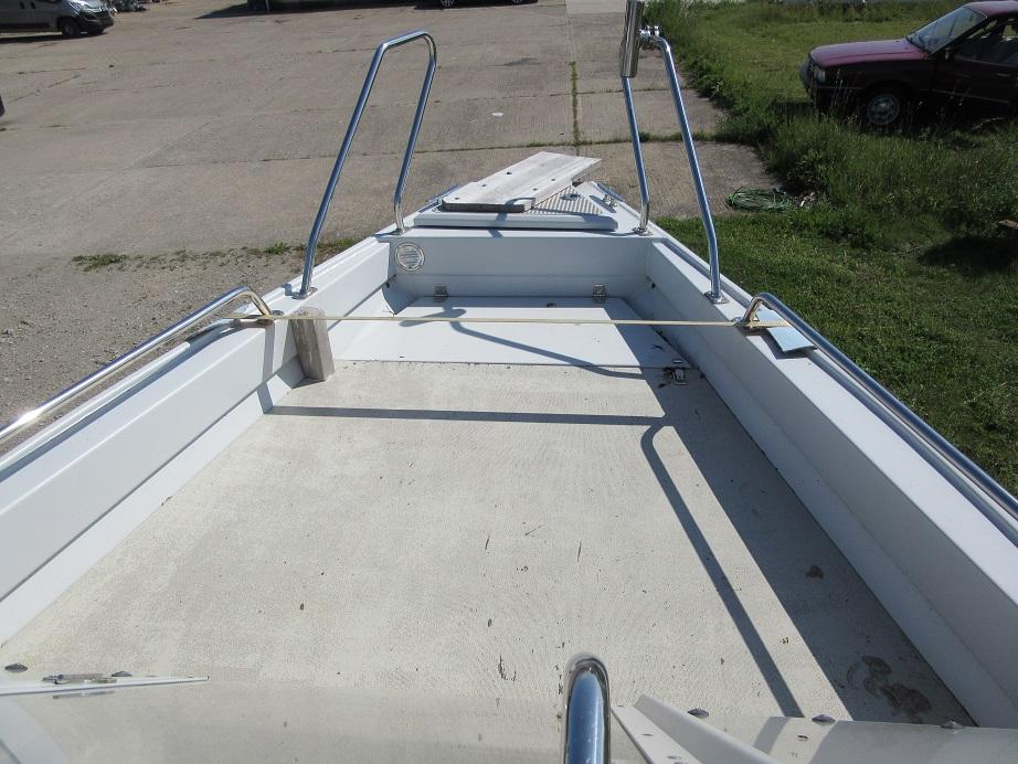Open deck of a 2016 Master Pro 571 boat with metal railings.