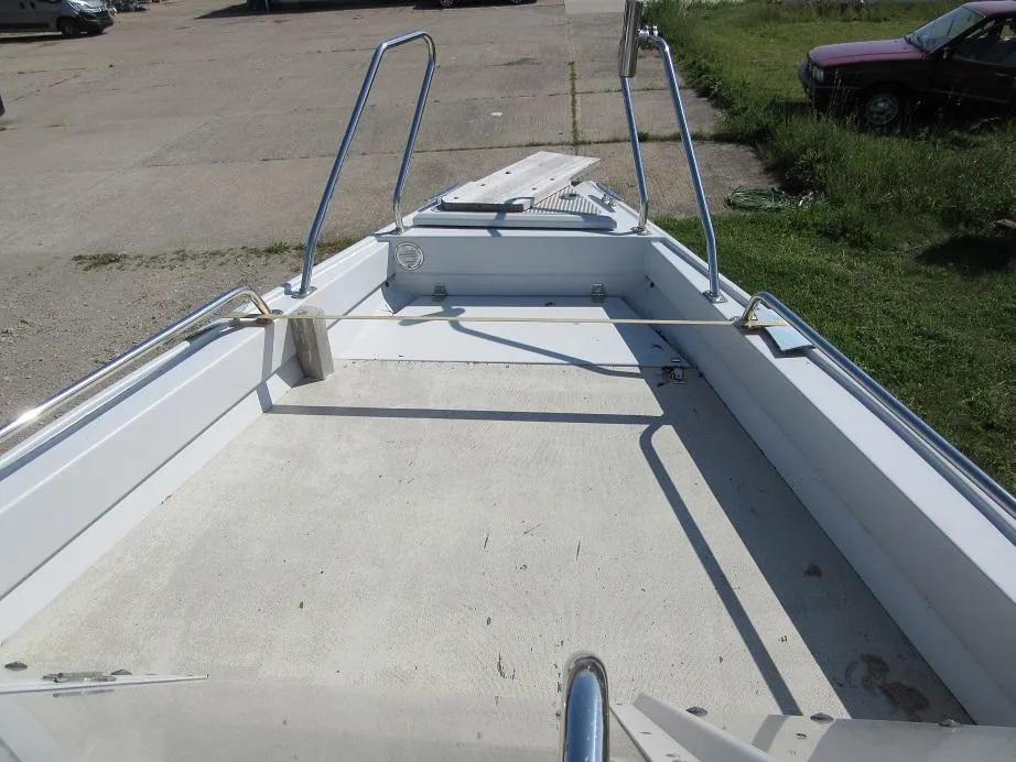 Open deck of a 2016 Master Pro 571 boat with metal railings.