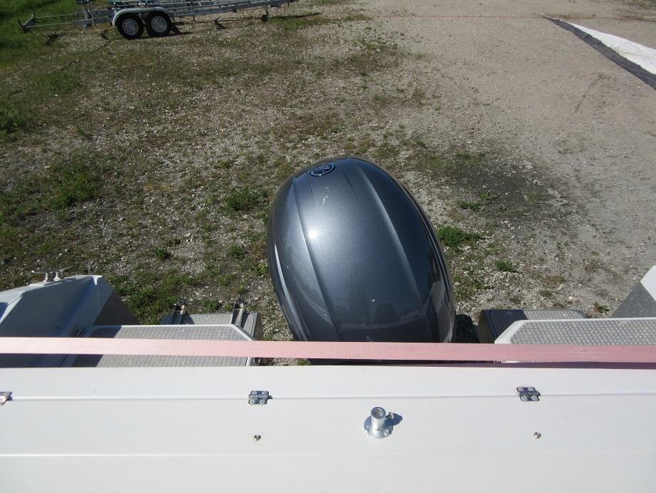 Top view of a 2016 Master Pro 571 outboard motor on a gravel surface.