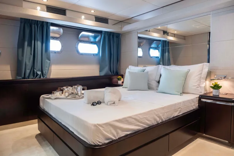 Bellini Yacht Photos Pics Luxurious bedroom interior on 1988 Cantieri di Pisa AKHIR 30 yacht, featuring elegant decor and natural light.