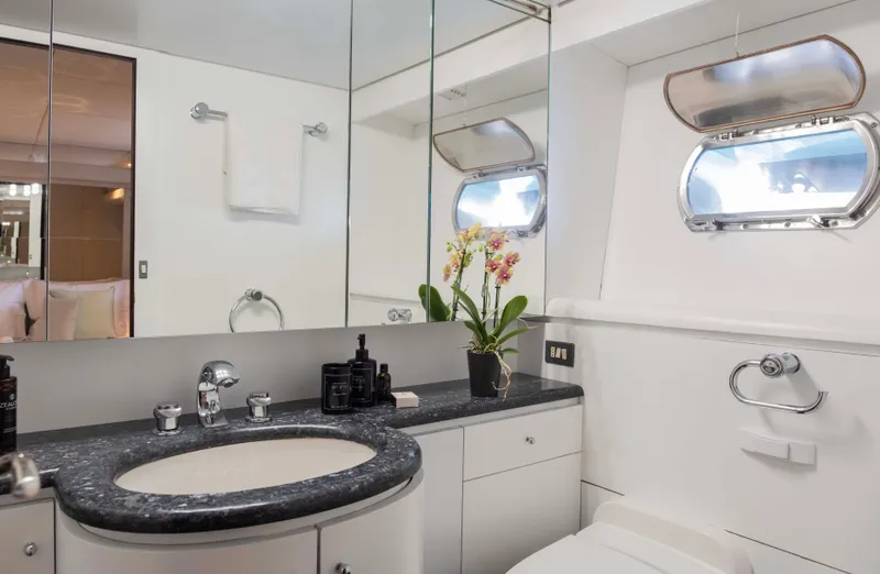 Bellini Yacht Photos Pics Luxurious bathroom on 1988 Cantieri di Pisa AKHIR 30 yacht with elegant fixtures and floral decor.