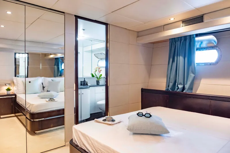 Bellini Yacht Photos Pics Luxurious bedroom interior on 1988 Cantieri di Pisa AKHIR 30 yacht, featuring elegant decor and natural light.