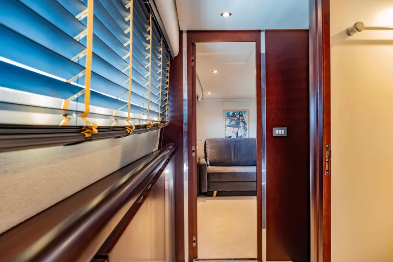 Bellini Yacht Photos Pics Interior hallway of 1988 Cantieri di Pisa AKHIR 30 yacht with wooden accents and blinds.