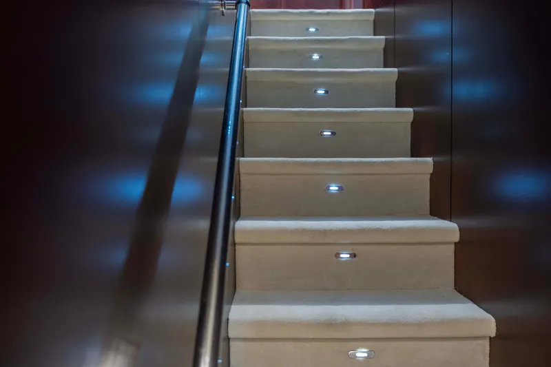 Bellini Yacht Photos Pics Illuminated staircase inside 1988 Cantieri di Pisa AKHIR 30 yacht, featuring modern lighting.