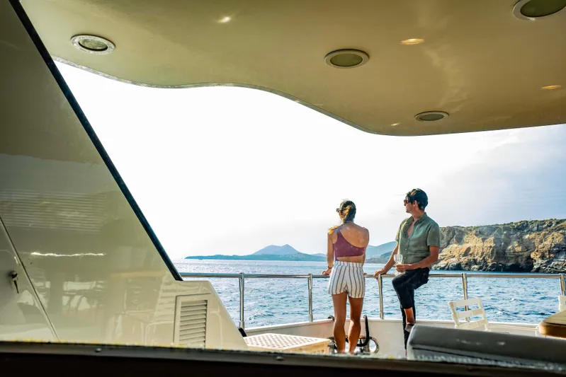 Bellini Yacht Photos Pics Couple enjoying ocean view on Cantieri di Pisa AKHIR 30 yacht, 1988 model.