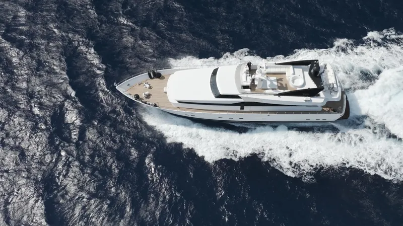 Bellini Yacht Photos Pics Aerial view of 1988 Cantieri di Pisa AKHIR 30 yacht cruising on open sea.